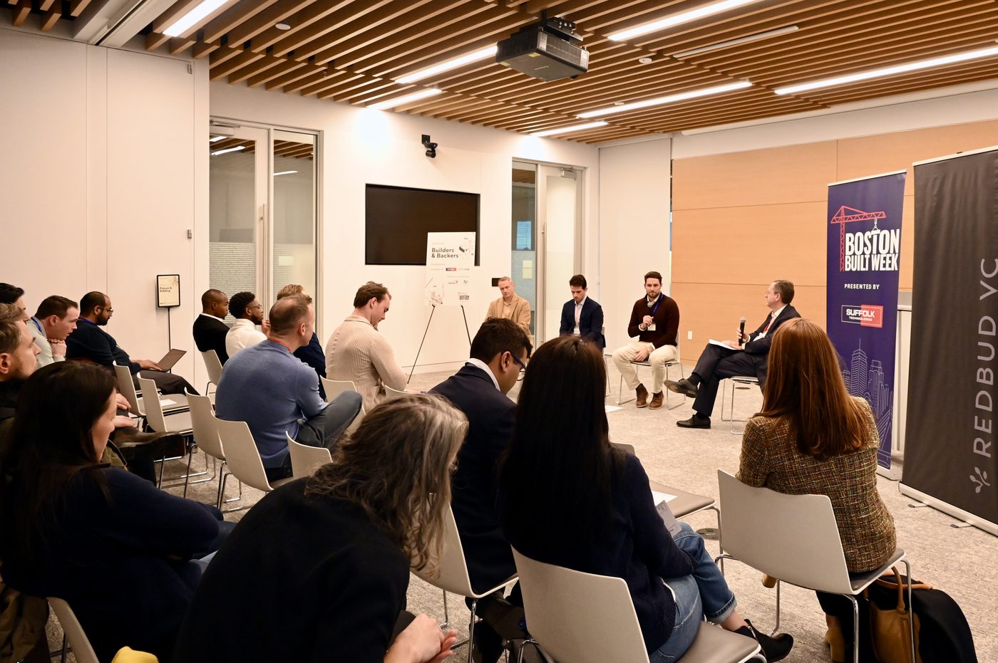 Attendees seated in a discussion circle at Builders and Backers